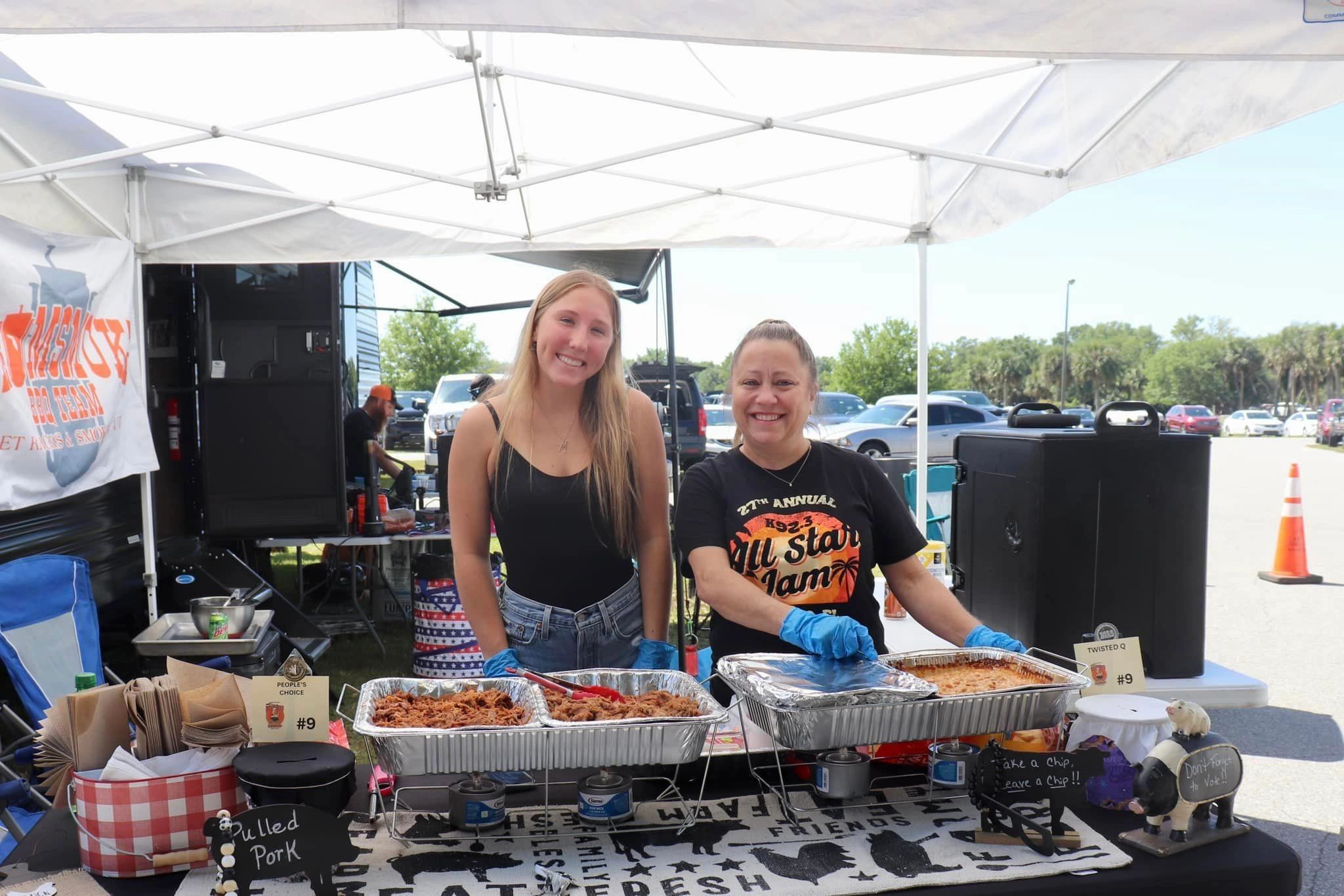 Volunteers serving BBQ at the Sharing Center event